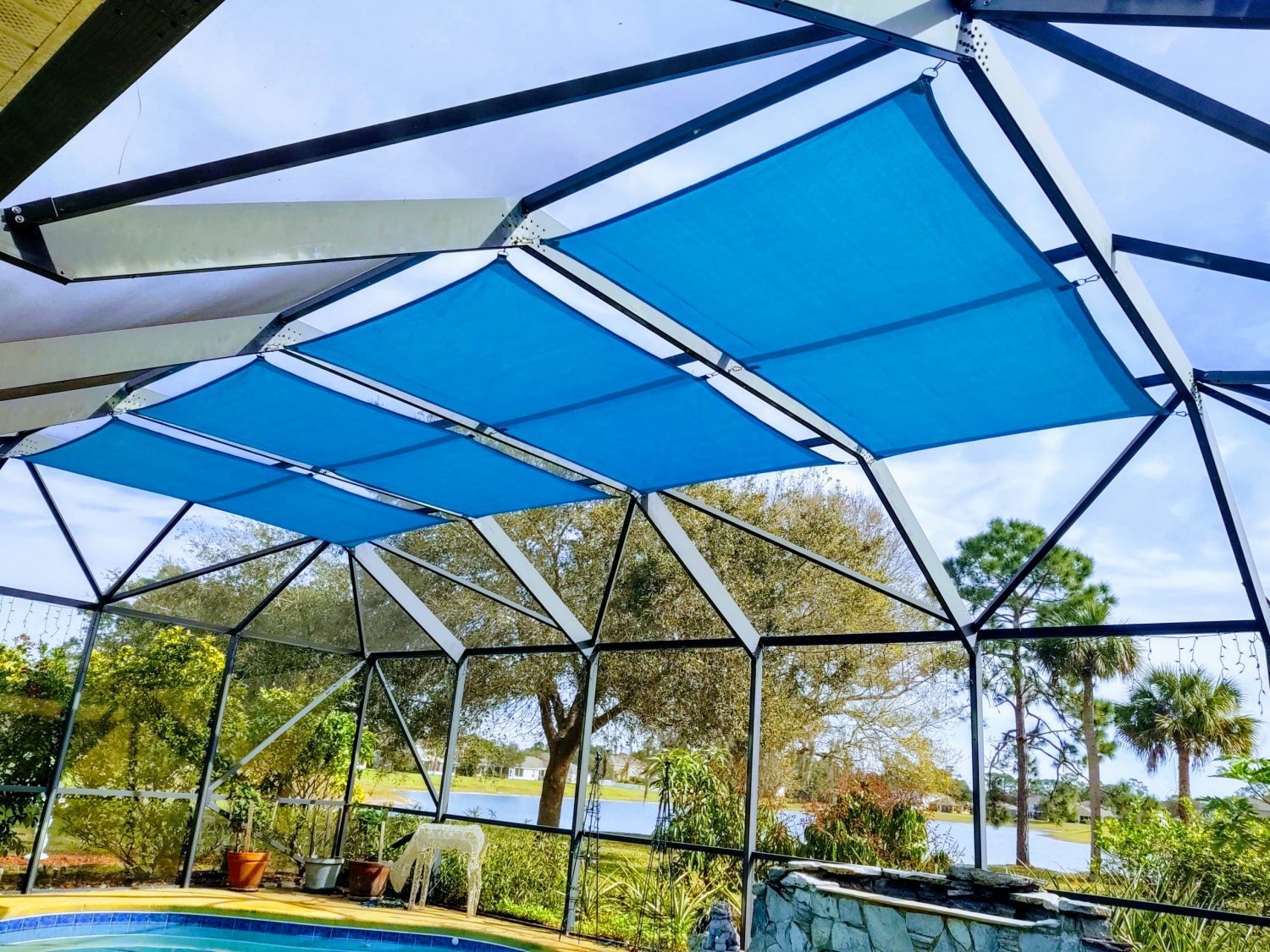 Outdoor privacy curtains on a Miami-area screen enclosure