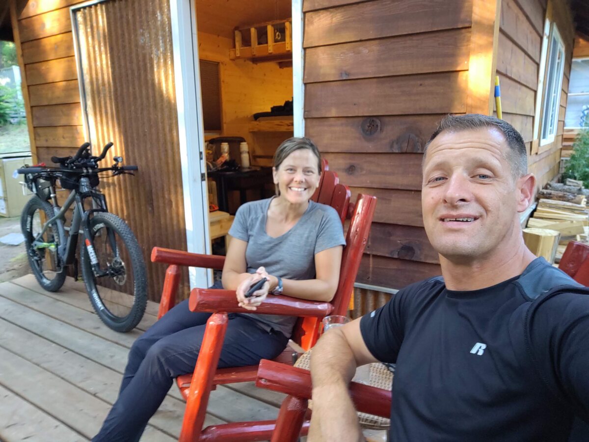Emily and Merrill Burrows relaxing on a cabin porch